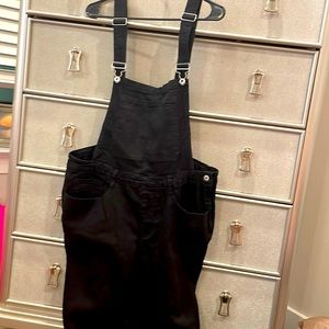 Black Overalls with silver hardware., skinny leg design., pockets on both sides
